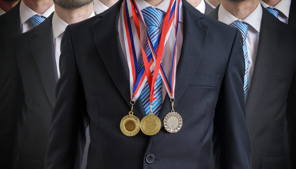 man wearing three medals