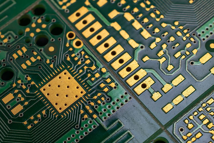 Angled close up photo of a green and gold printed circuit board