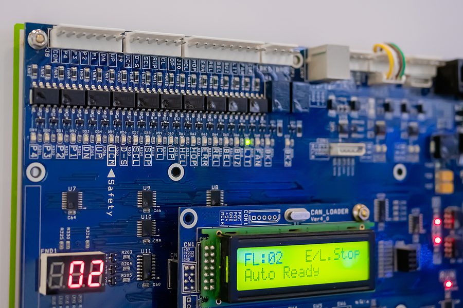 Close up of blue mounted PCB board with digital display.