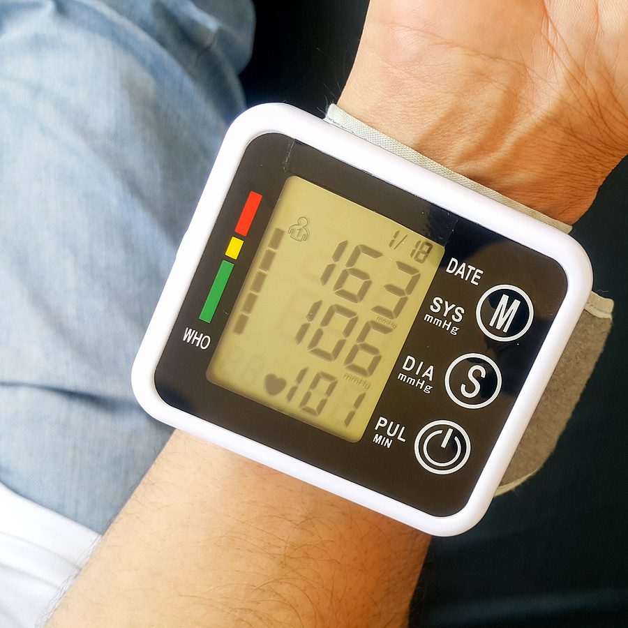 Close up of a patient wearing a medical device on their wrist. 